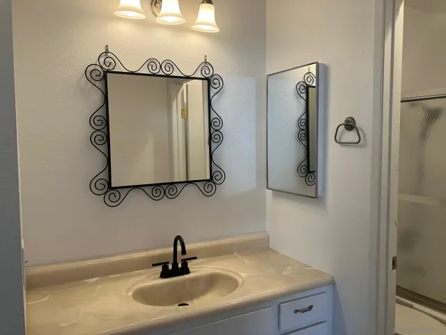 a bathroom with a sink and mirror