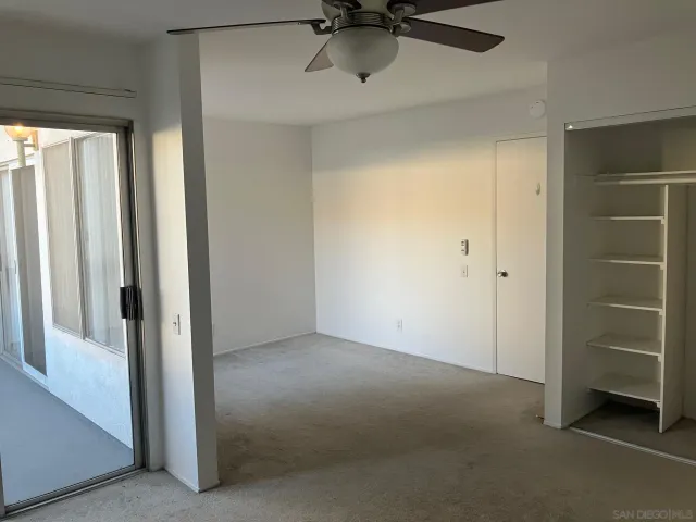 a view of a room with a ceiling fan