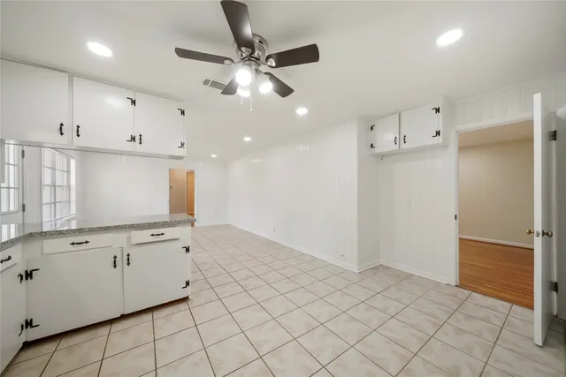 a view of a kitchen with white cabinets