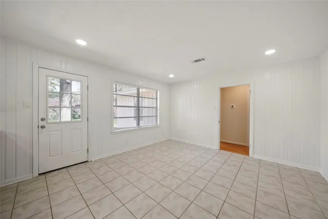 an empty room with windows and closet