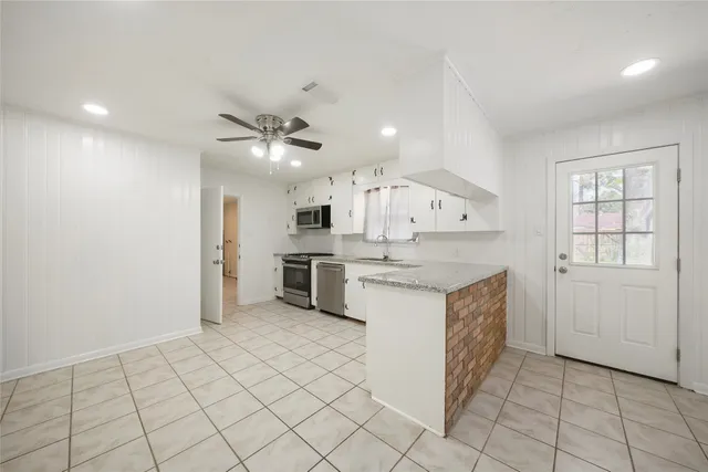 a kitchen with a sink a stove and cabinets