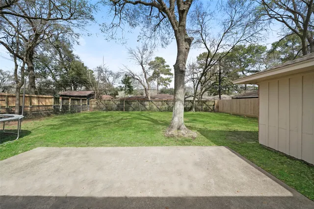 a view of a house with backyard and a sitting area