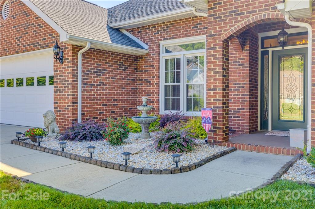711 Monticello Drive Fort Mill, SC 29708 - Photo 2 of 45 a view of a brick house with potted plants