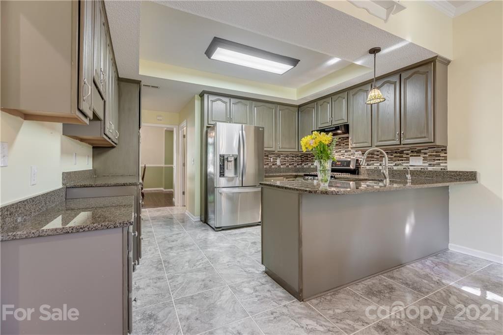 711 Monticello Drive Fort Mill, SC 29708 - Photo 11 of 45 a kitchen with stainless steel appliances granite countertop a refrigerator and a stove