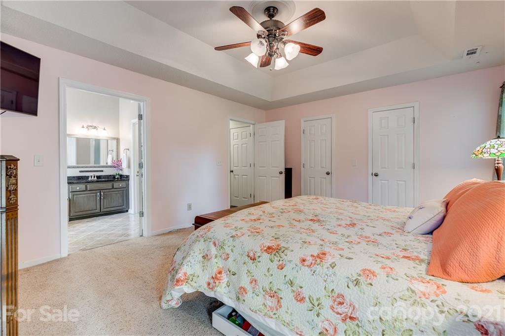 711 Monticello Drive Fort Mill, SC 29708 - Photo 21 of 45 a bedroom with a bed and a chandelier