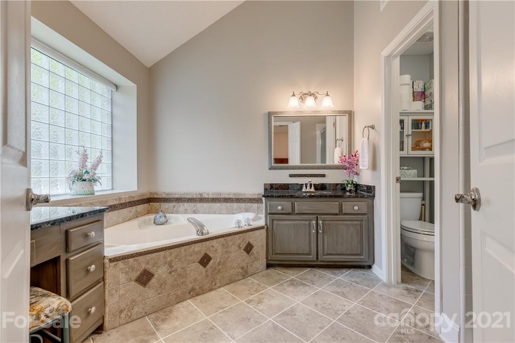 711 Monticello Drive Fort Mill, SC 29708 - Photo 22 of 45 a spacious bathroom with a granite countertop sink and a bathtub
