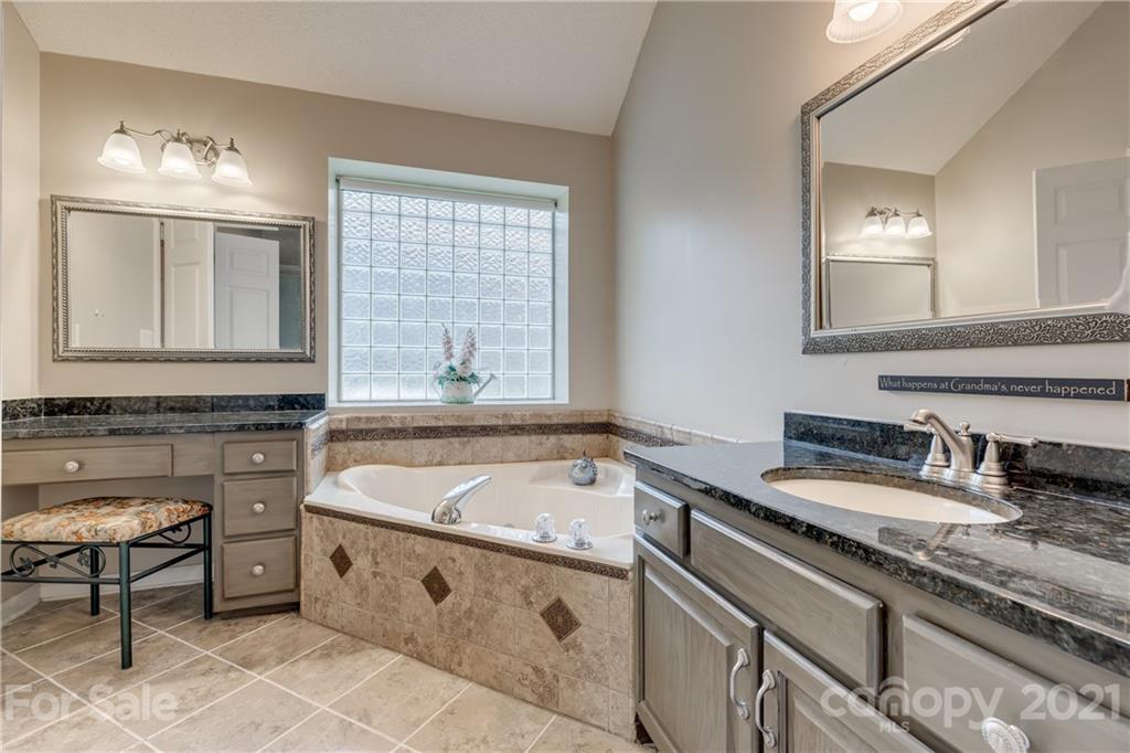 711 Monticello Drive Fort Mill, SC 29708 - Photo 23 of 45 a bathroom with a tub sink and mirror