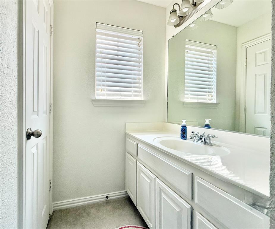 2754 Ridge View Road Frisco, TX 75034 - Photo 24 of 34 a bathroom with a sink a vanity and a window