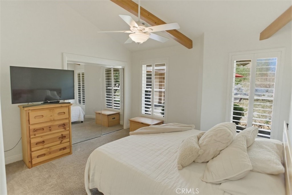 31233 Romero Canyon Road Castaic, CA 91384 - Photo 26 of 38 a bedroom with a large bed and a flat screen tv