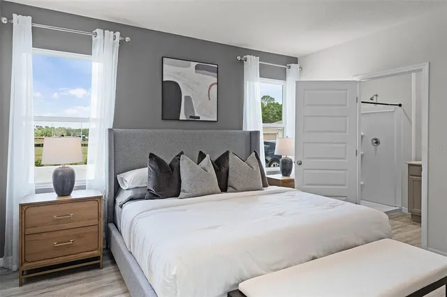 a bedroom with a large bed and a dresser