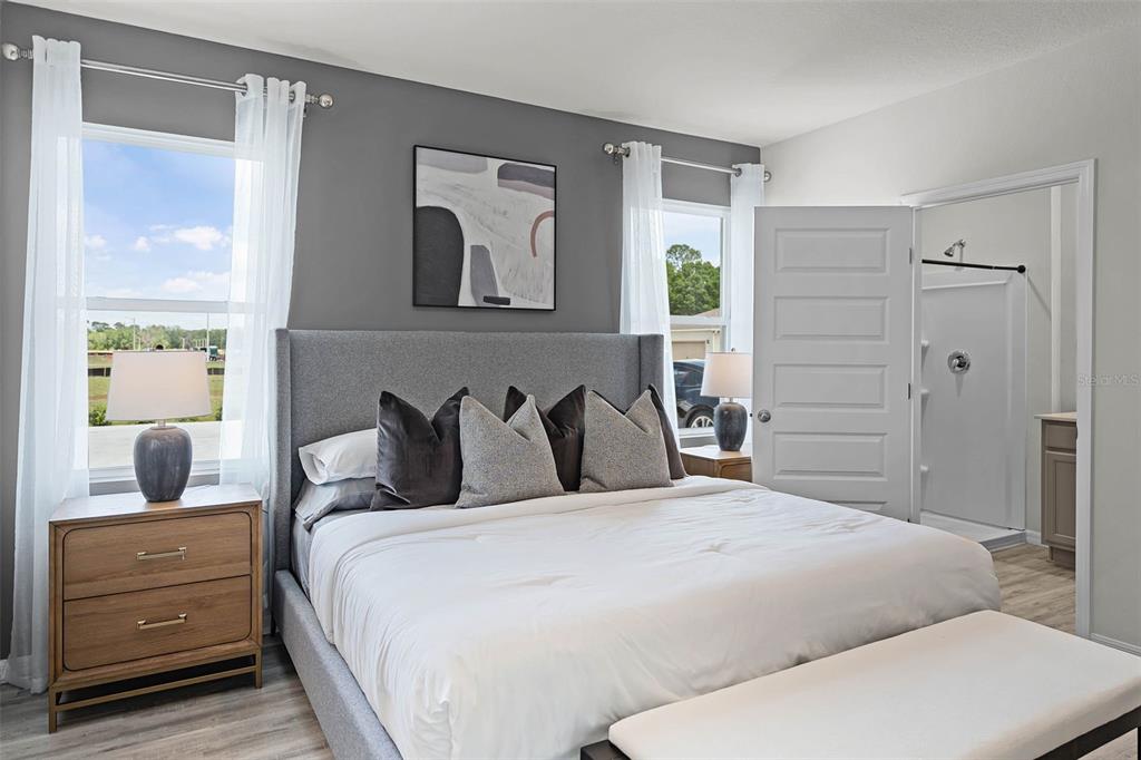 3421 Nettle Loop Tavares, FL 32778 - Photo 12 of 30 a bedroom with a large bed and a dresser