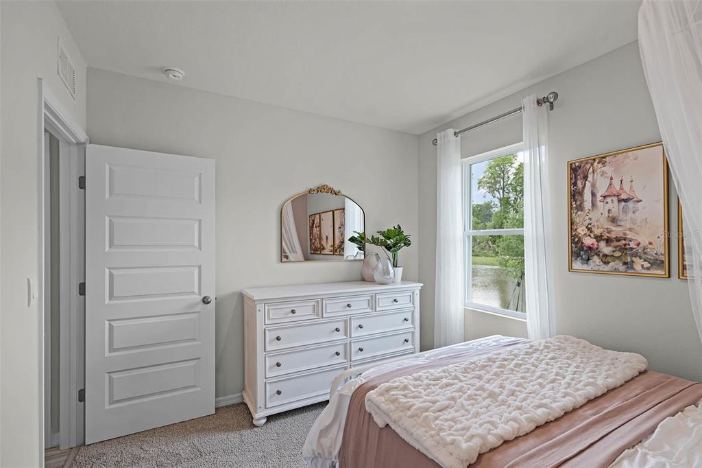 3421 Nettle Loop Tavares, FL 32778 - Photo 21 of 30 a bedroom with a bed and a dresser