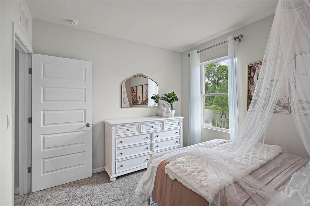 3421 Nettle Loop Tavares, FL 32778 - Photo 22 of 30 a bedroom with a bed and a dresser