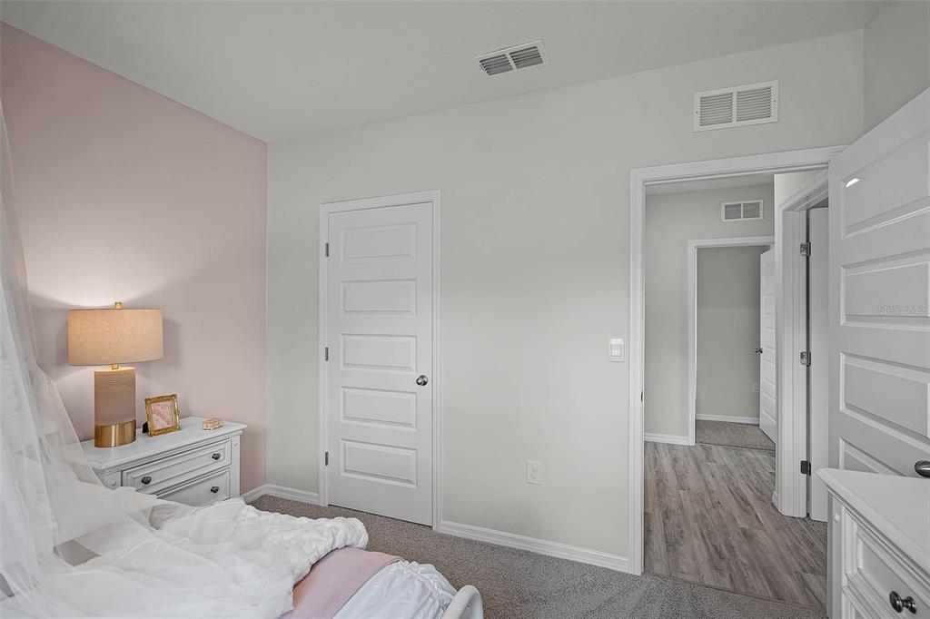 3421 Nettle Loop Tavares, FL 32778 - Photo 24 of 30 a room with a bed and a tv on the dresser