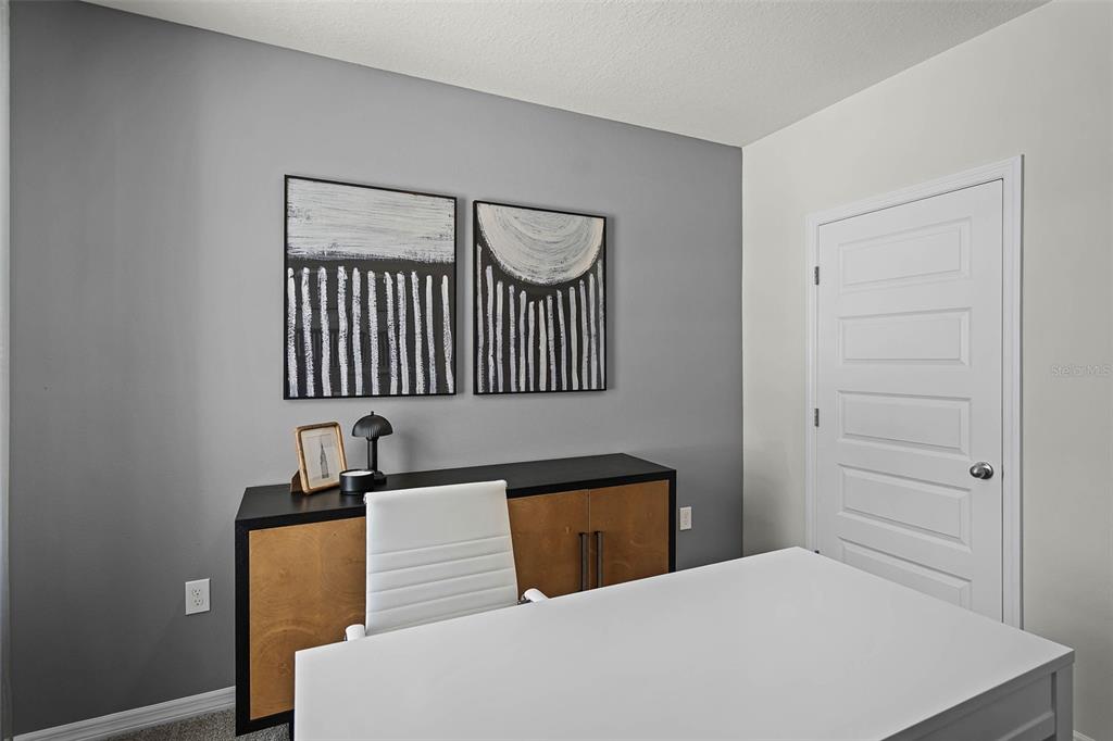 3421 Nettle Loop Tavares, FL 32778 - Photo 26 of 30 a bedroom with a bed and a lamp on dresser