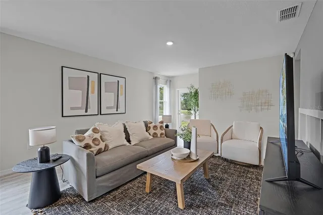 a living room with furniture and a lamp