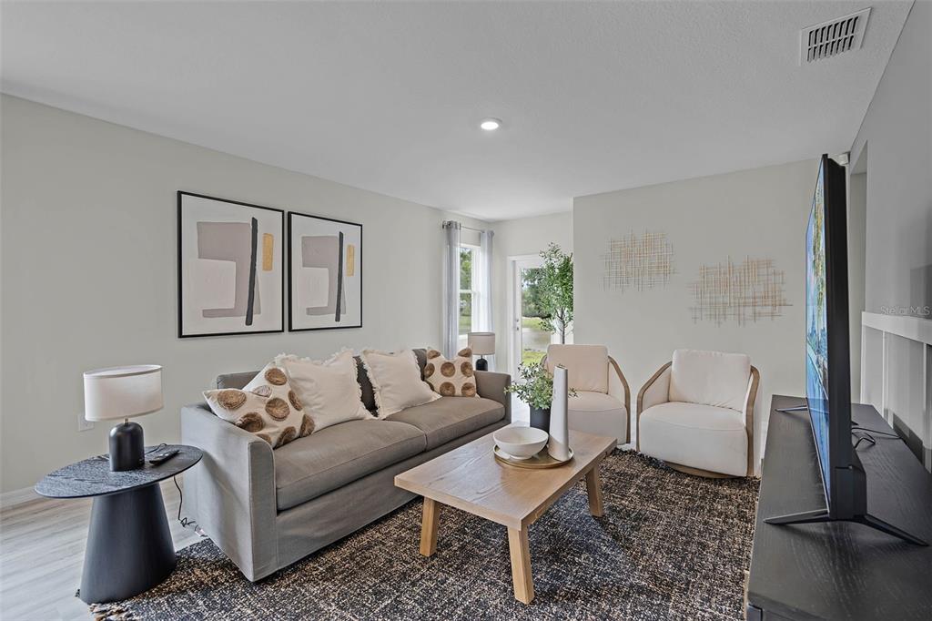 3421 Nettle Loop Tavares, FL 32778 - Photo 4 of 30 a living room with furniture and a lamp