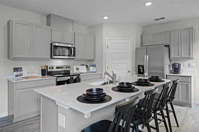 a kitchen with a stove a sink and a refrigerator