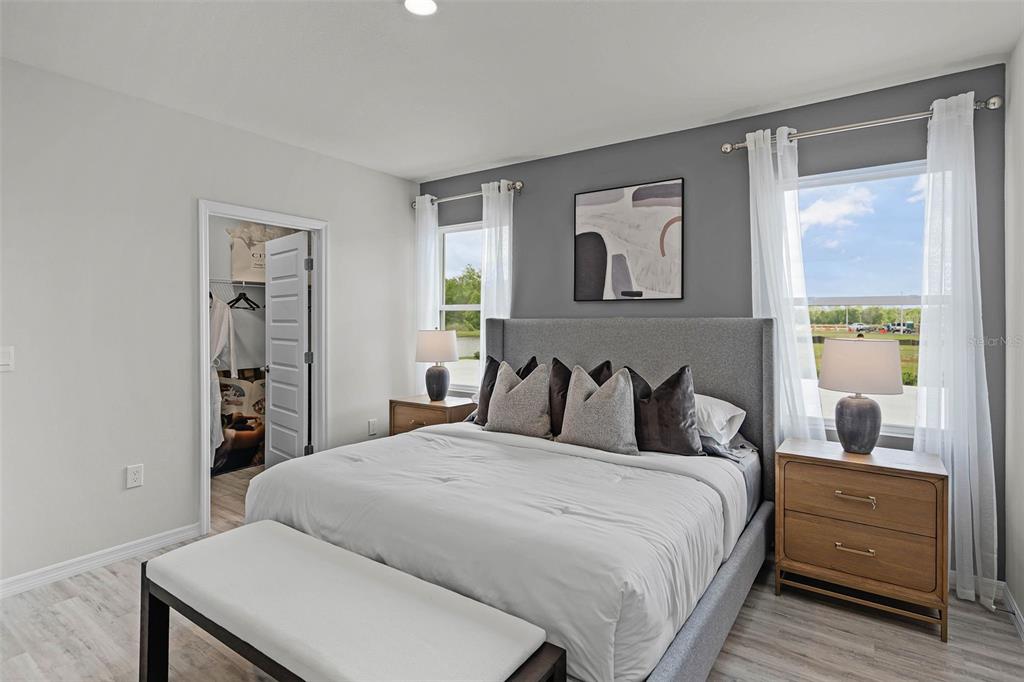 3421 Nettle Loop Tavares, FL 32778 - Photo 10 of 30 a bedroom with a large bed and a window