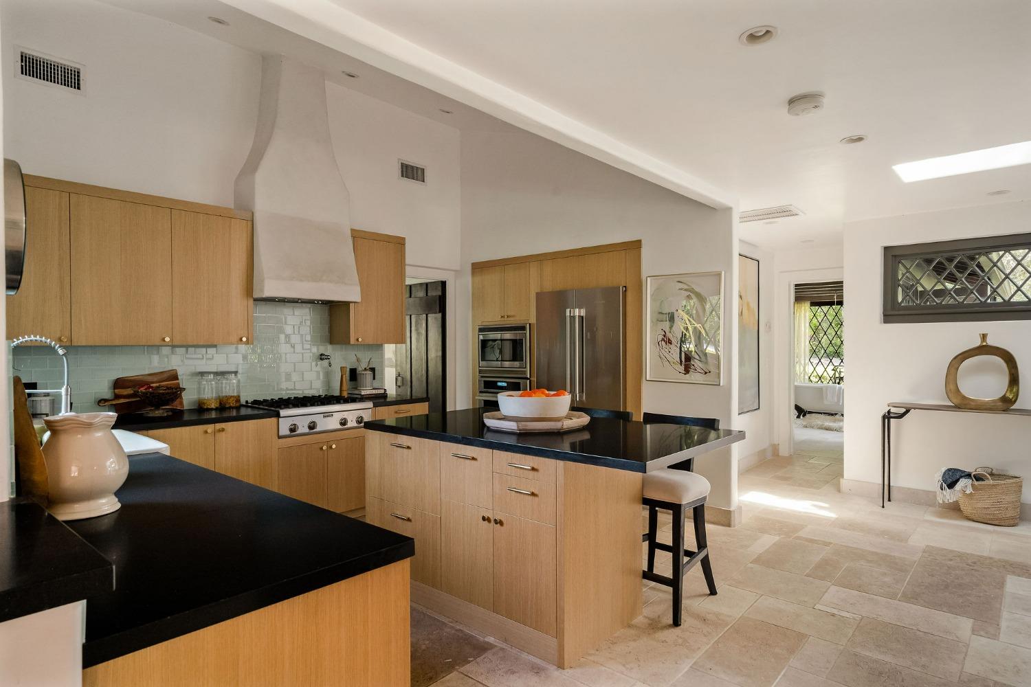 1001 Foothill Road Ojai, CA 93023 - Photo 16 of 50 a kitchen with a sink a stove cabinets and a dining table