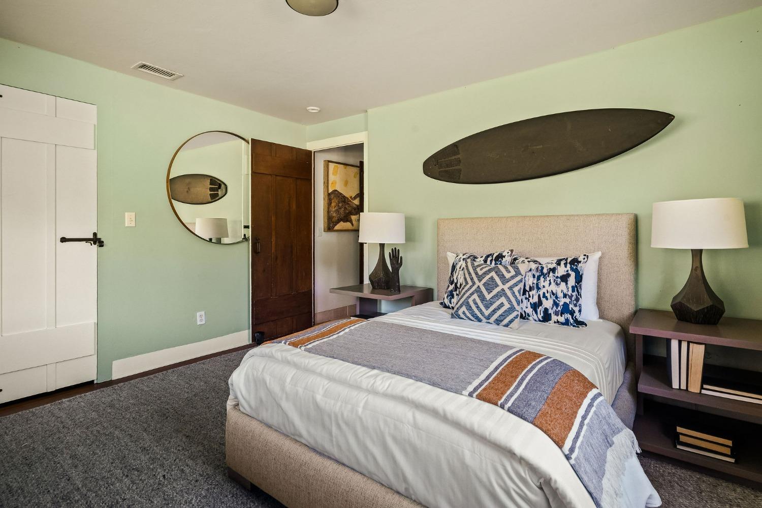 1001 Foothill Road Ojai, CA 93023 - Photo 34 of 50 a bedroom with a bed and a lamp