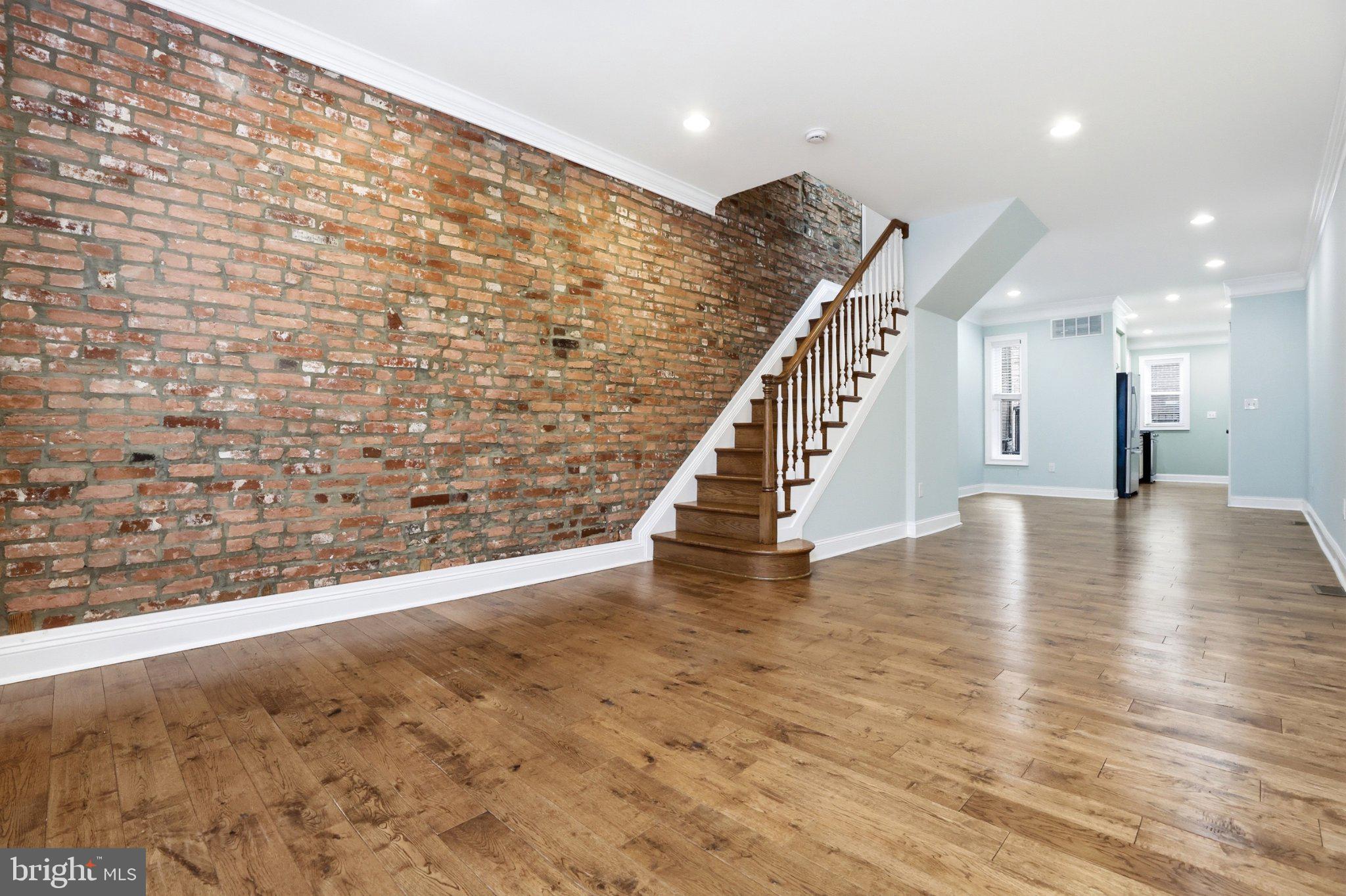 222 South Exeter Street Baltimore, MD 21202 - Photo 5 of 41 a view of an empty room with wooden floor