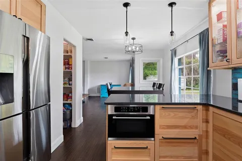 a kitchen with stainless steel appliances a refrigerator and a stove