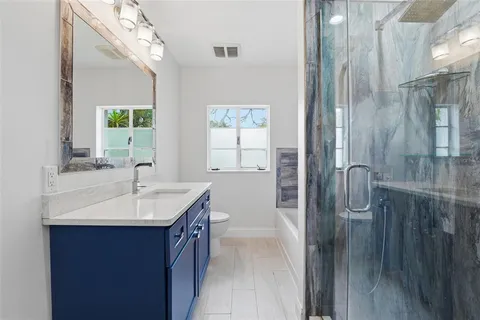 a en suite bathroom with a sink a mirror and a shower