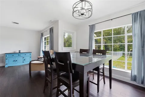 a view of a dining room with furniture window and wooden floor