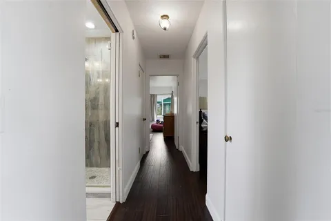 a view of a hallway with wooden floor