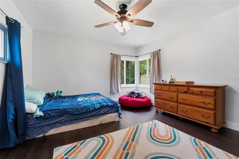 a bedroom with bed and a chandelier
