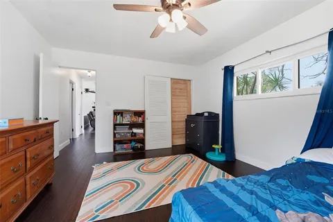 a bed room with a bed and a television