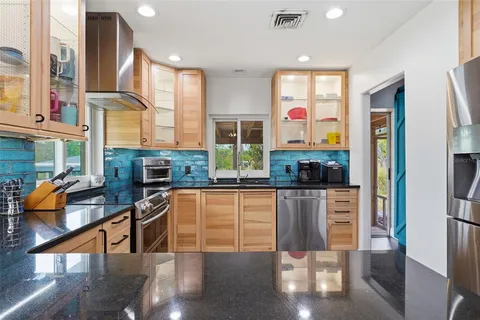 a kitchen with stainless steel appliances granite countertop a stove and a refrigerator