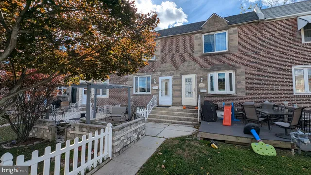 a view of a house with a yard and sitting area