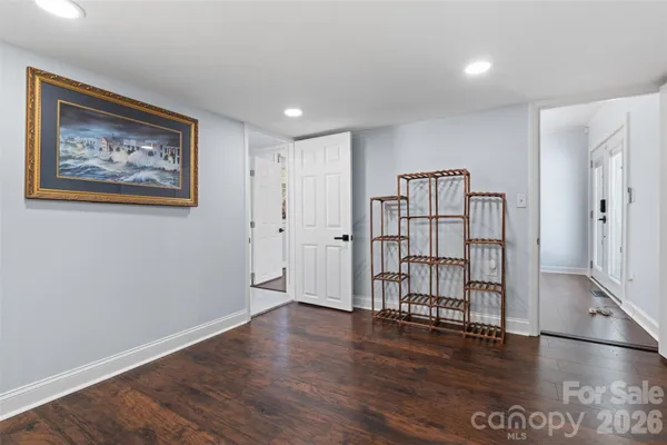 a view of empty room with wooden floor