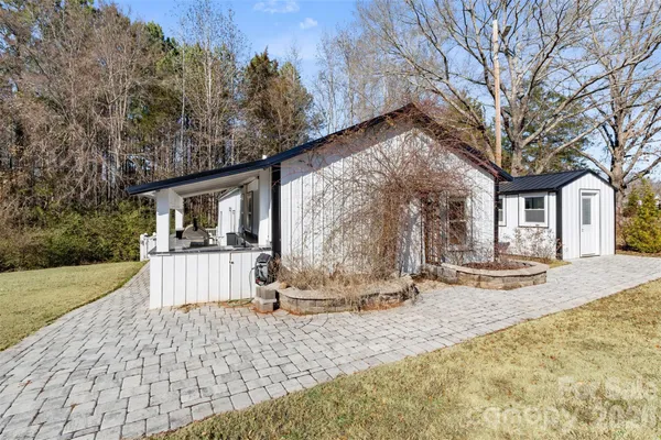 a view of a house with backyard and trees