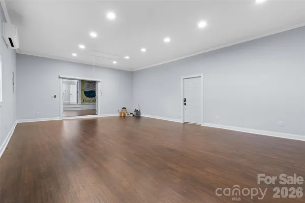 a view of empty room with wooden floor
