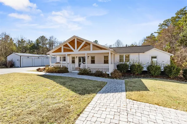 a front view of a house with swimming pool having outdoor seating