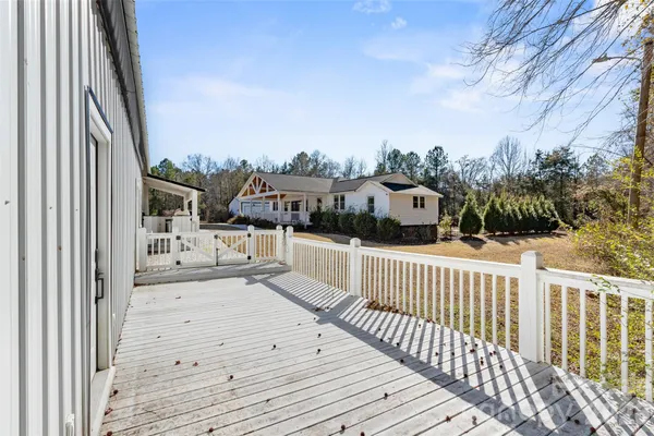 a view of a house with backyard and deck