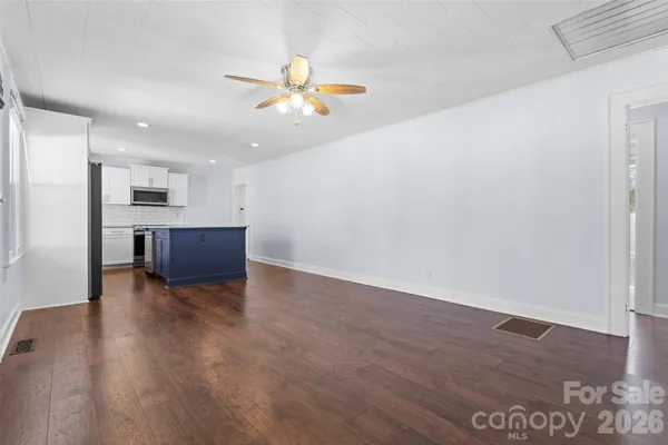 a view of kitchen and hall with wooden floor
