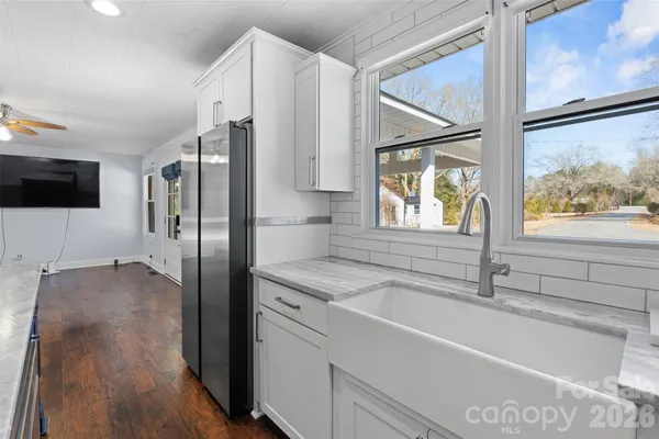 a kitchen with stainless steel appliances granite countertop a refrigerator and a sink