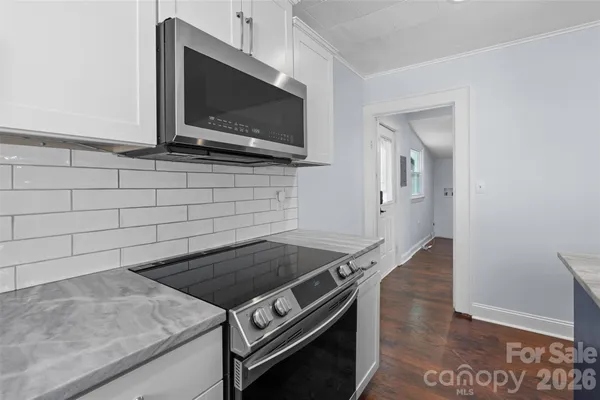 a kitchen with a stove and a microwave