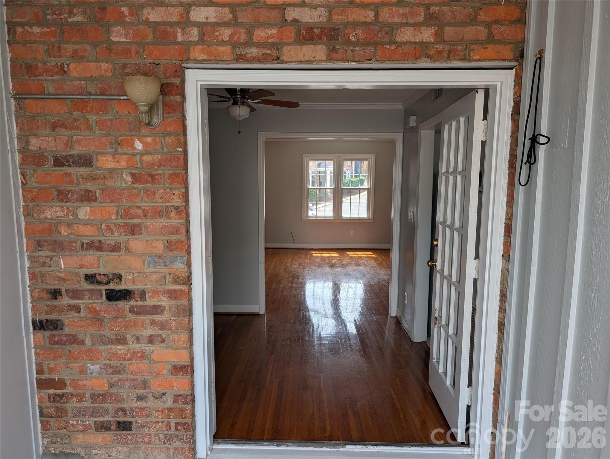 916 McAlway Road, Unit D Charlotte, NC 28211 - Photo 3 of 12 a view of a hallway with wooden floor and a living room