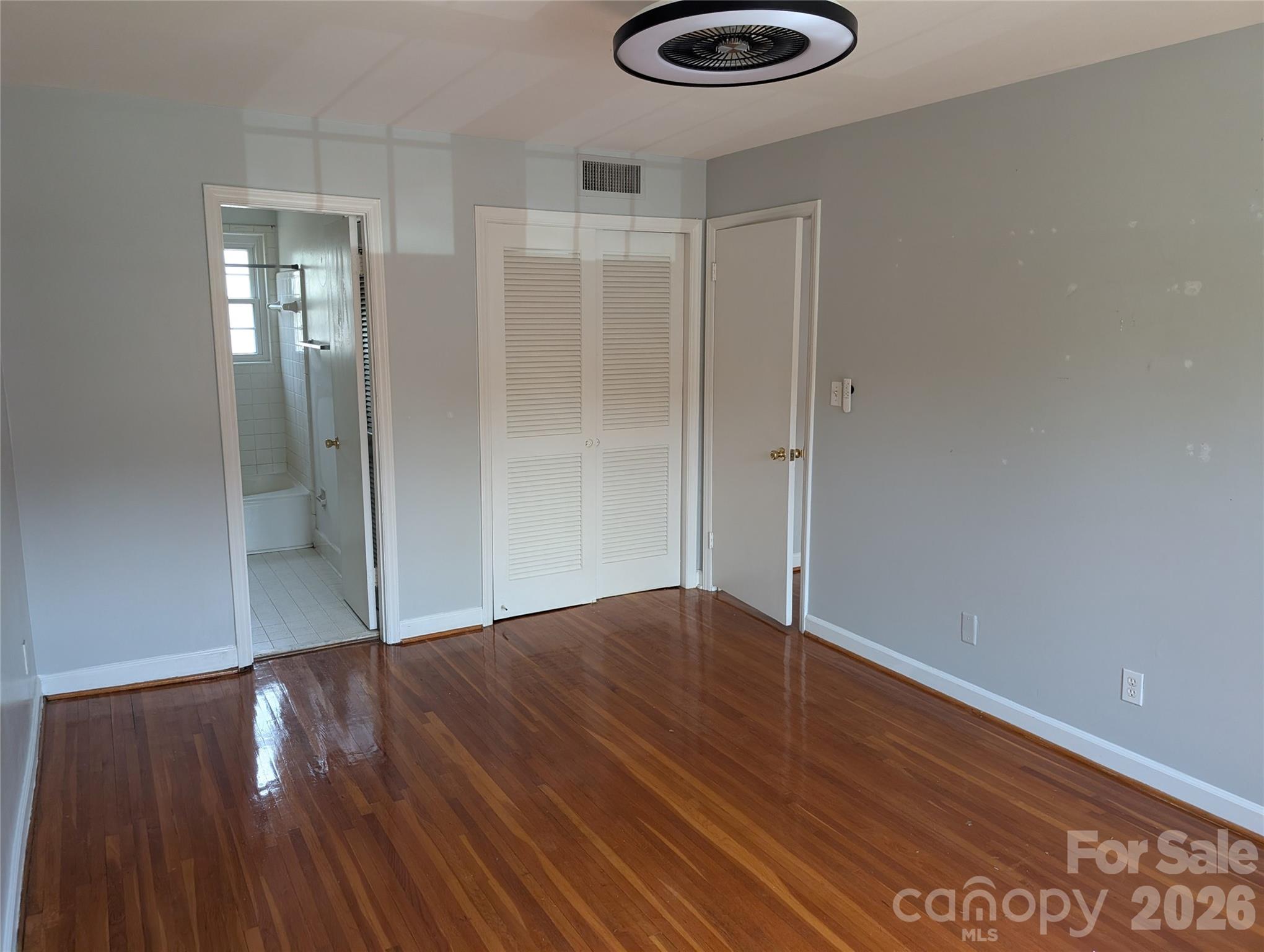 916 McAlway Road, Unit D Charlotte, NC 28211 - Photo 5 of 12 a view of an empty room with wooden floor