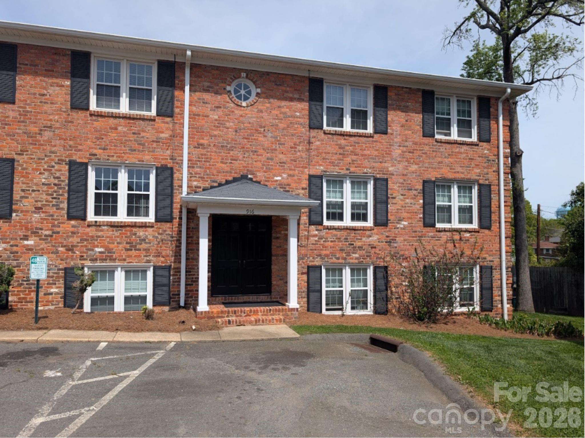 916 McAlway Road, Unit D Charlotte, NC 28211 - Photo 9 of 12 a front view of a brick house with a yard