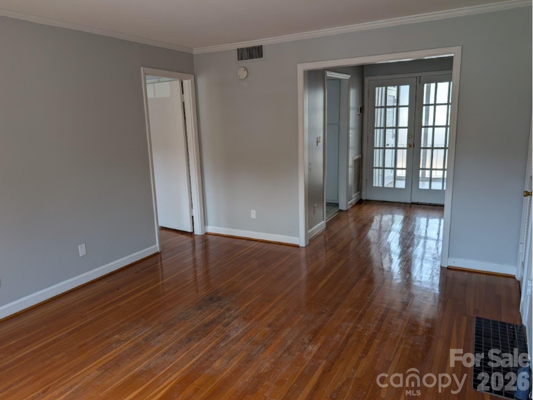 916 McAlway Road, Unit D Charlotte, NC 28211 - Photo 10 of 12 wooden floor in an empty room with a window