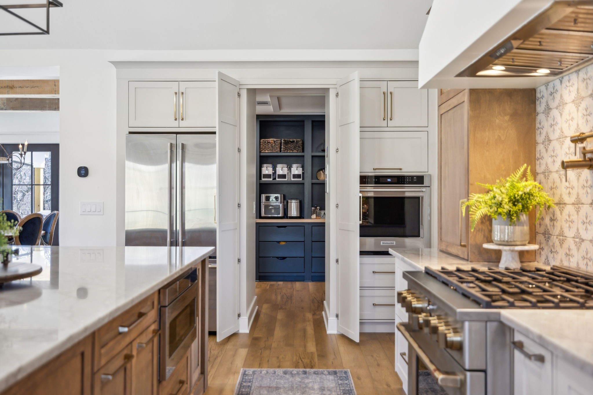 4676 Reed Road Thompson's Station, TN 37179 - Photo 17 of 67 a kitchen with granite countertop a stove and a refrigerator