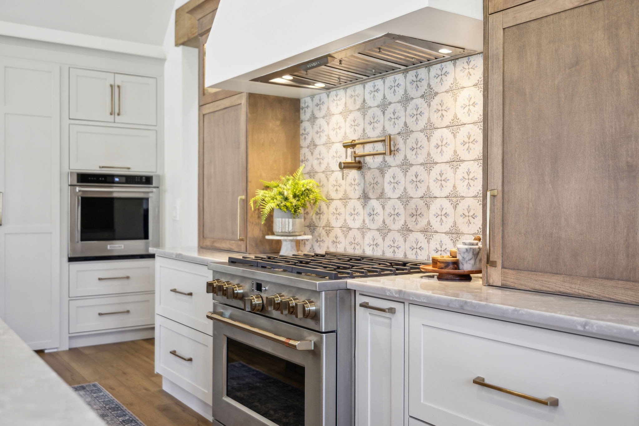 4676 Reed Road Thompson's Station, TN 37179 - Photo 18 of 67 a kitchen with stainless steel appliances a stove and a white cabinet