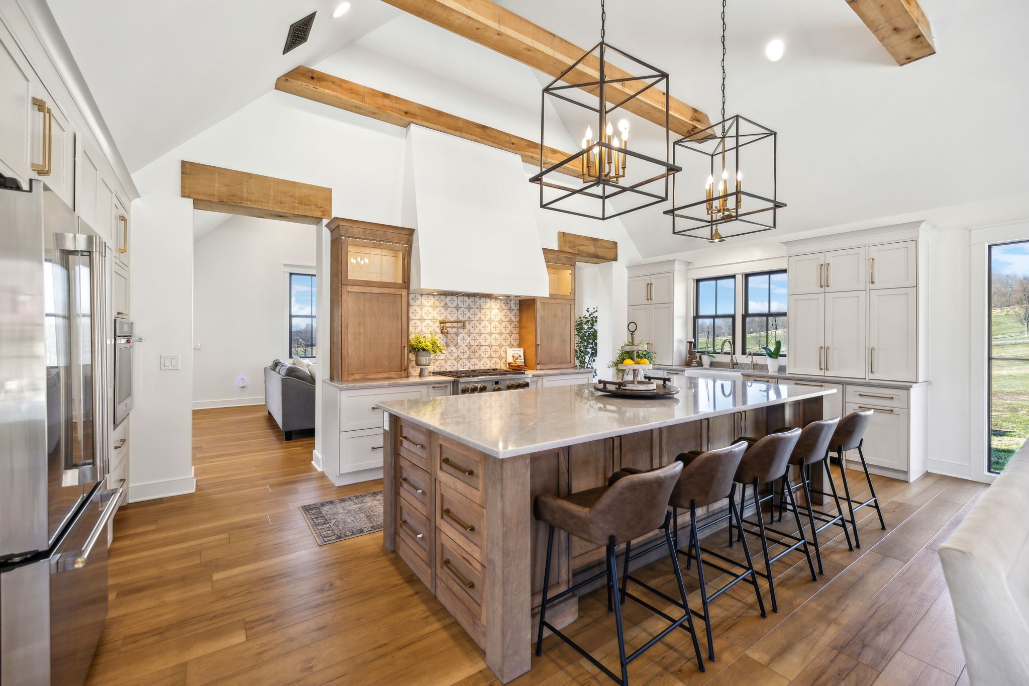 4676 Reed Road Thompson's Station, TN 37179 - Photo 21 of 67 a kitchen with stainless steel appliances granite countertop a table chairs and a chandelier