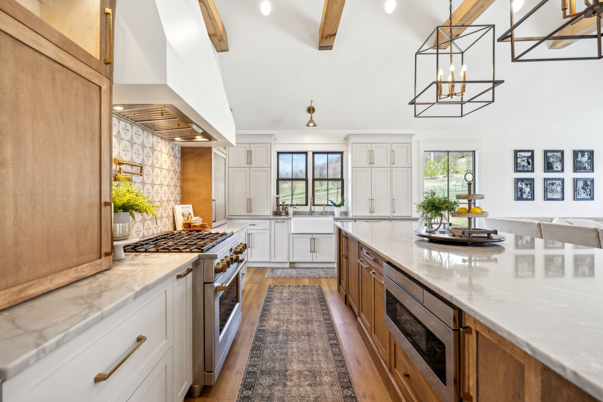 4676 Reed Road Thompson's Station, TN 37179 - Photo 22 of 67 a kitchen with stainless steel appliances granite countertop lots of counter top space and wooden floor